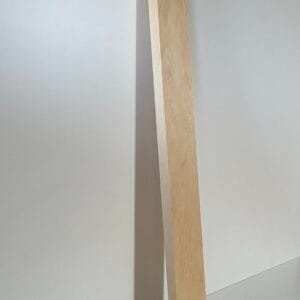 a wooden plank leaning against a wall