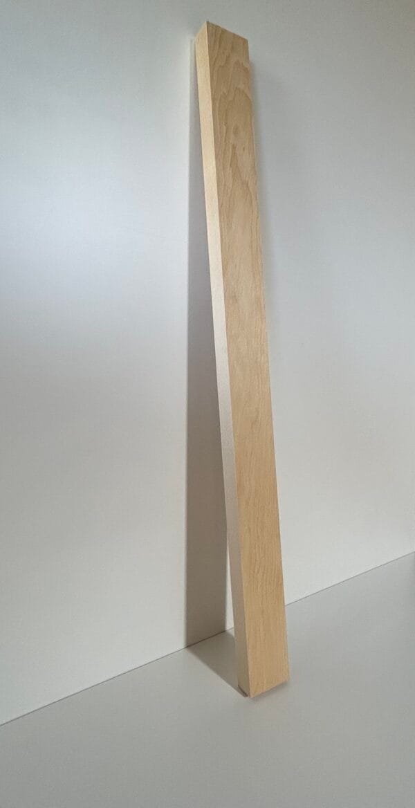 a wooden plank leaning against a wall