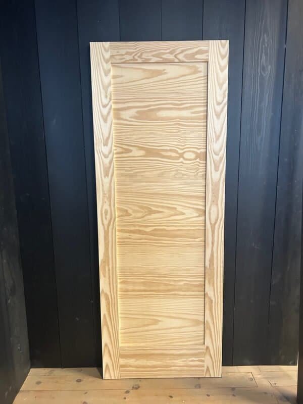 a wood door with a black wall