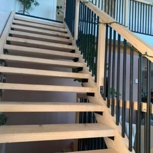 a wooden stairs with black railings