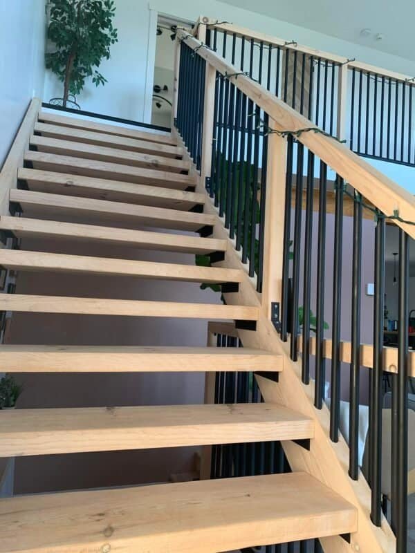 a wooden stairs with black railings